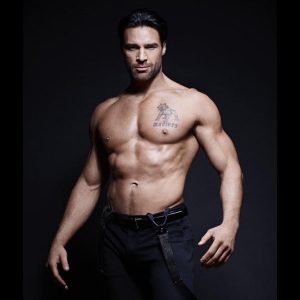 Charles Dera shirtless in black slacks